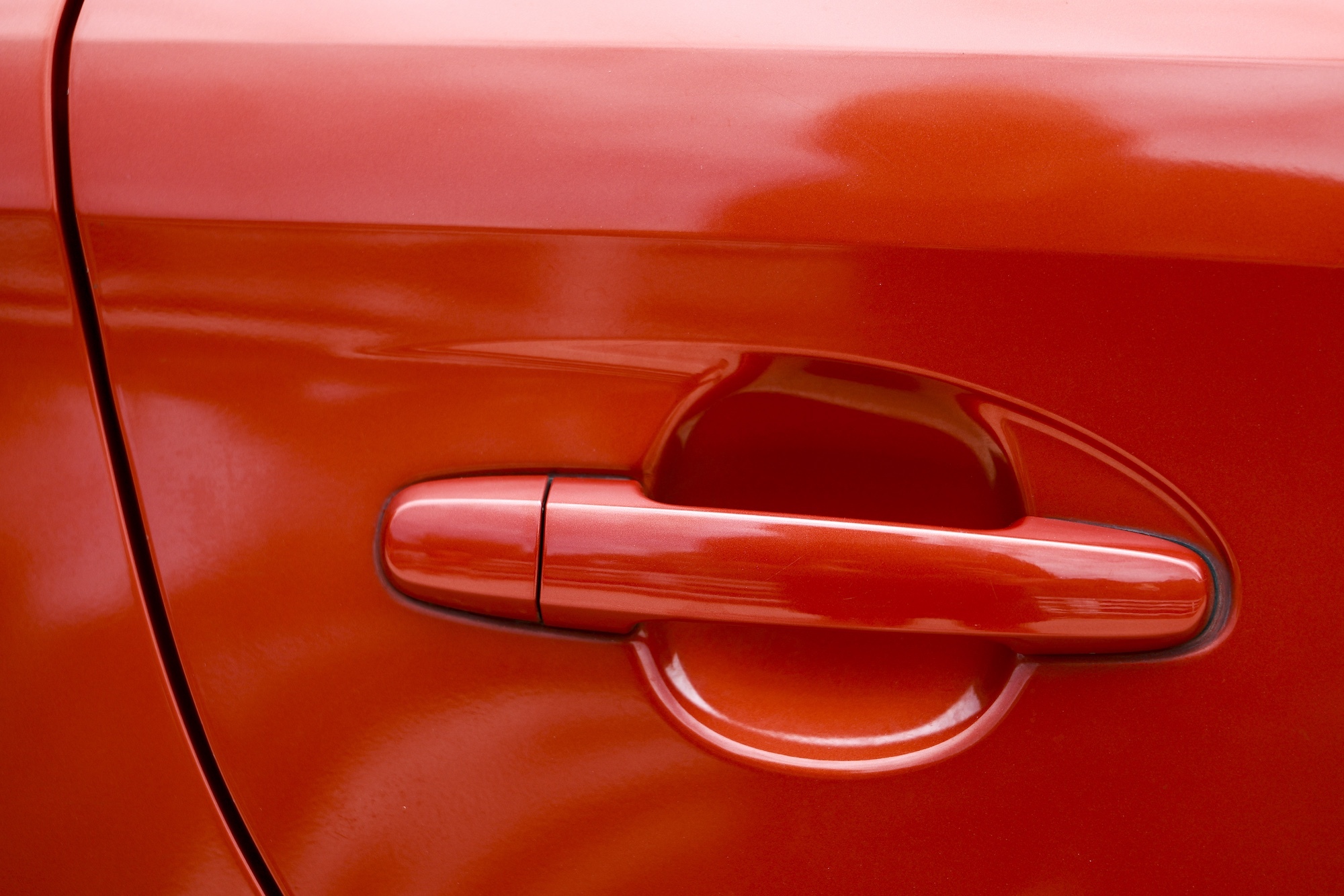 Close-up of a red car door handle